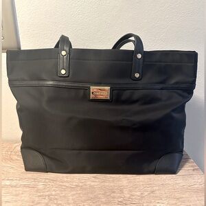 Black Calvin Klein bag with top magnetic button closure